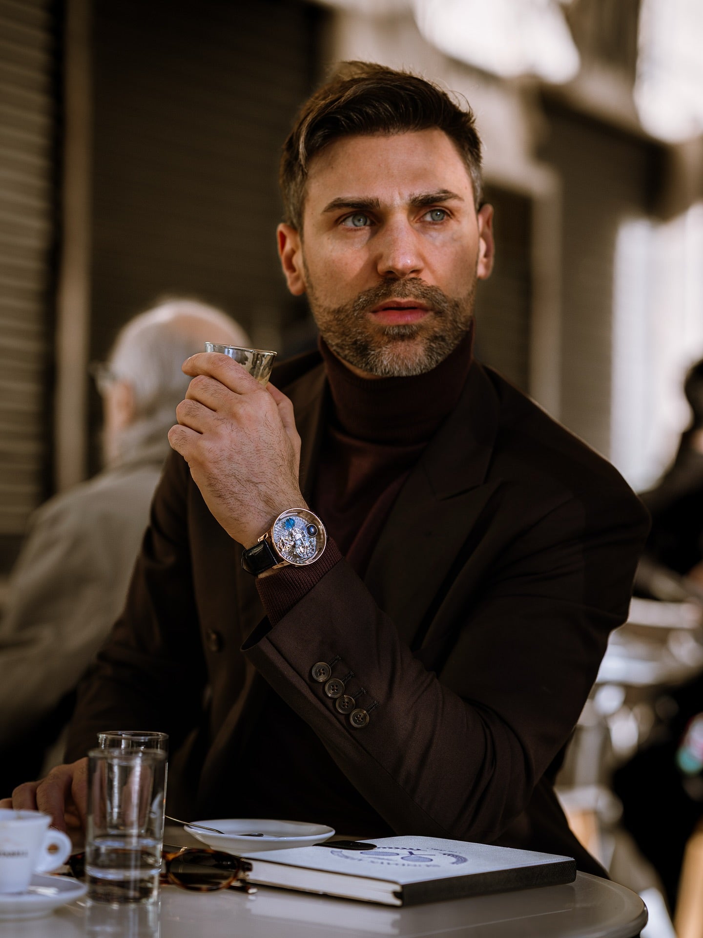 Mauro Littera wearing a GEYA watch at a cafe